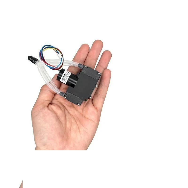 Hand holding OD-05T01.52000B brushless micro diaphragm pump to show size
