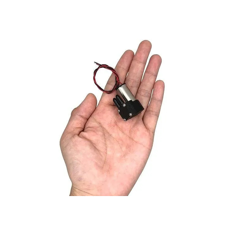 Ultra-lightweight mini diaphragm pump shown in hand for size comparison OD-05T01530