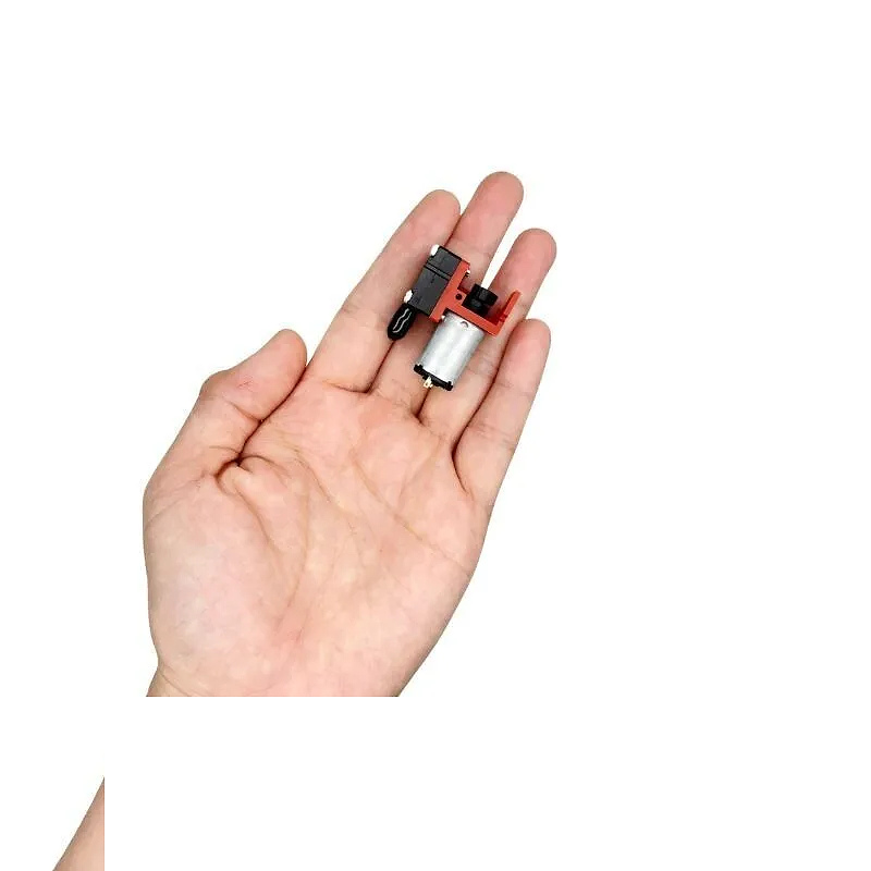 OD-05T02500 mini diaphragm pump held in hand for scale