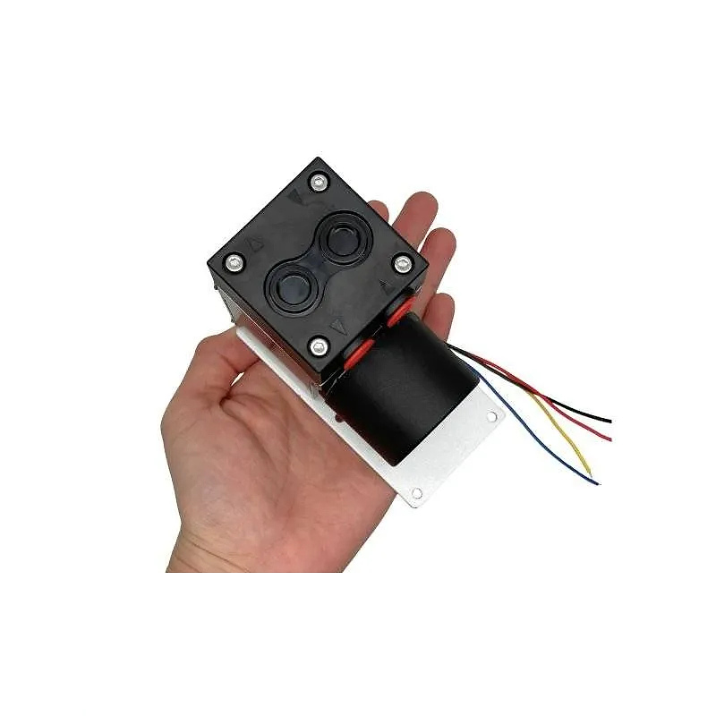 Hand holding OD-05T067L diaphragm gas pump for size reference